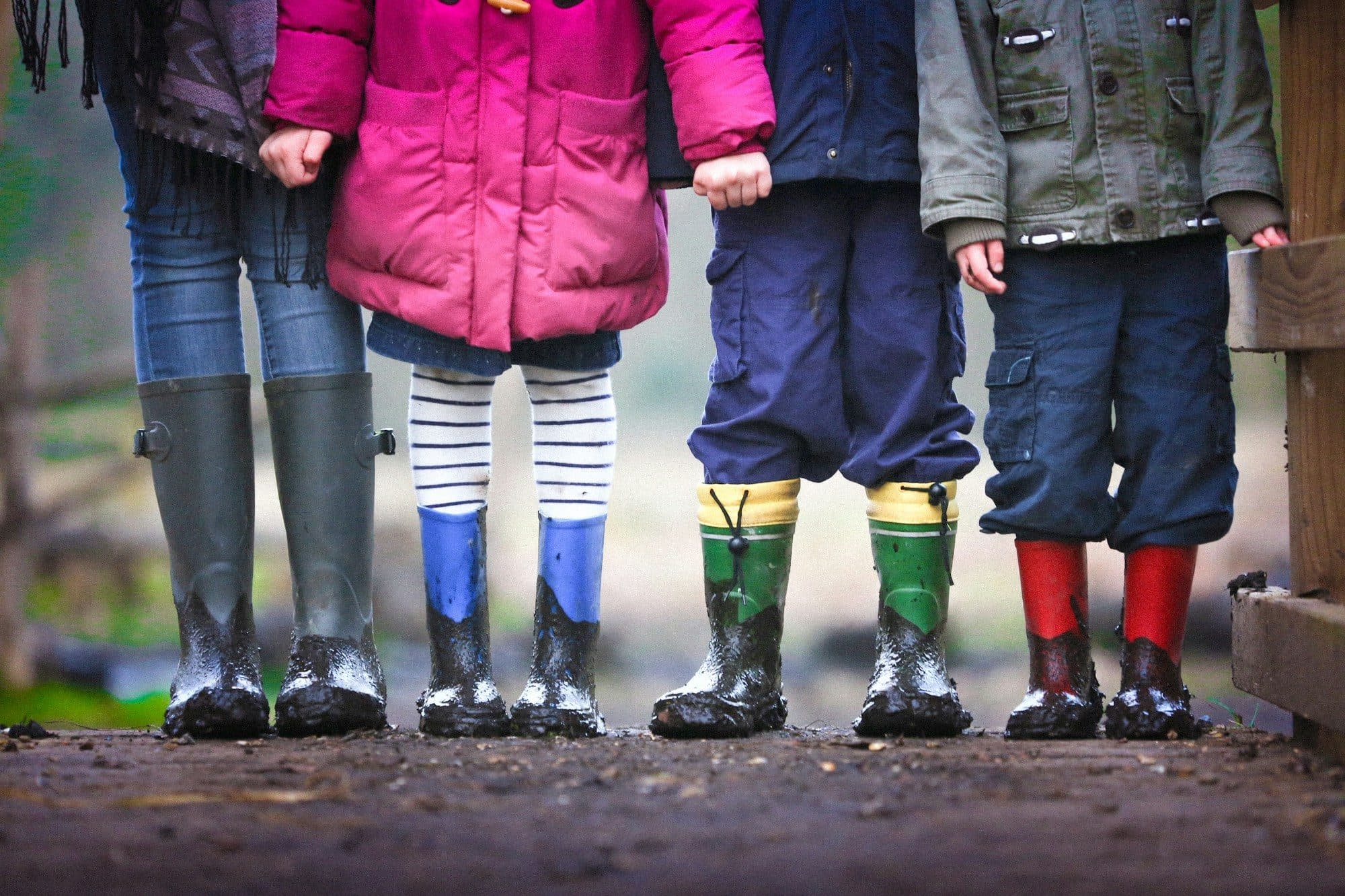 Row of pupils in colourful wellington boots