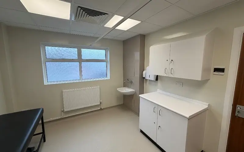 Modern office building with a clean, contemporary design, featuring large windows and a sleek facade.